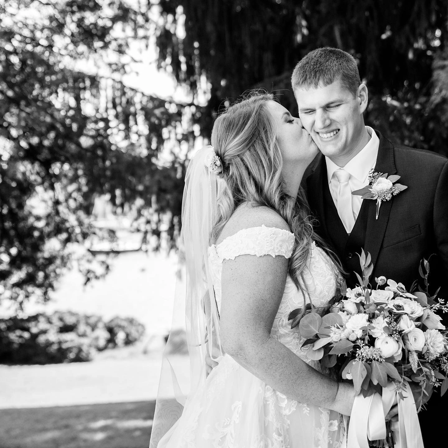 A couple with a hand-tied bouquet in the quiet minute after the ceremony