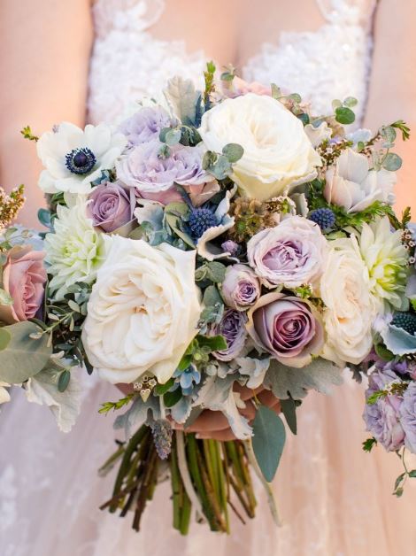 Bridal bouquet of lavender and mauve roses, white garden roses, dahlias and dusty miller